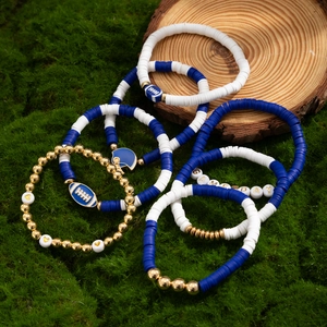 Detail of multi-layer beaded bracelet set with GAME DAY letters and football charms
