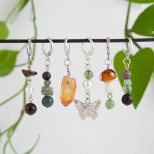 Detailed view of handmade beaded hair clip charms with crystal mushrooms and alloy butterflies