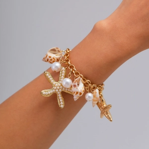Bohemian gold chain bracelet featuring white pearls, starfish, and natural seashell charms