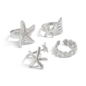 Detail of silver starfish and seashell ring set with adjustable bands and polished finish