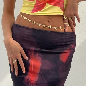 Detailed view of starfish and seashell rings set paired with a gold starfish belly chain