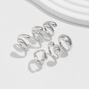 Detailed view of silver minimalist ring set with polished irregular geometric shapes