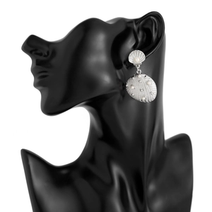 Detail view of silver shell earrings with pearls worn on a black jewelry bust display