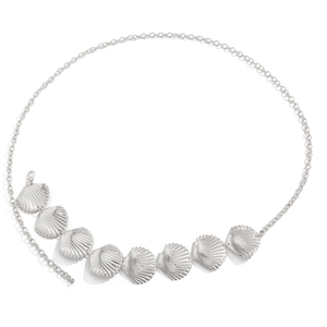 Close-up of silver metal body chain featuring polished seashell charms on a link chain