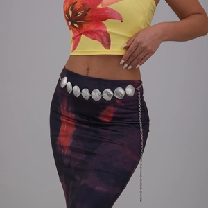 Detail of silver shell metal body chain with adjustable links on model waist