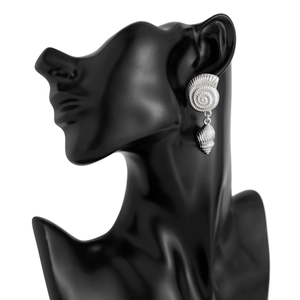 Macro detail of silver nautilus stud and hanging conch shell earring on model
