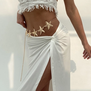 Detail of golden starfish charm waist chain with bohemian beach style metal elements