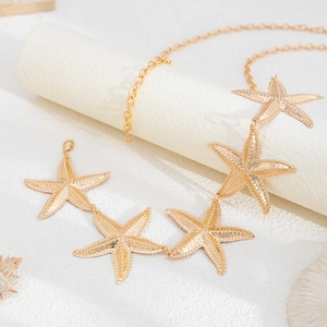 Detailed view of golden starfish pendants on a chain with lobster clasp and extension