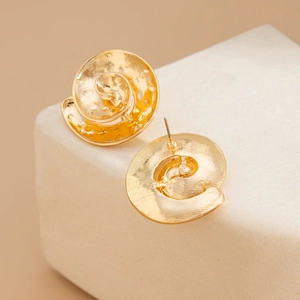 Macro view of gold spiral starfish earrings with unique hammered texture and pin backing