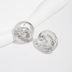 Close-up of silver metal starfish stud earrings with textured hammer finish for parties