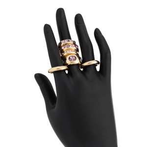 Detailed macro view of gold hollow rings set with pink and purple oval gemstones