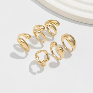 Detail view of 6-piece minimalist gold alloy ring set with irregular wave and water drop designs