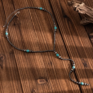 Detail of vintage beaded Y-necklace with turquoise beads and adjustable lobster clasp