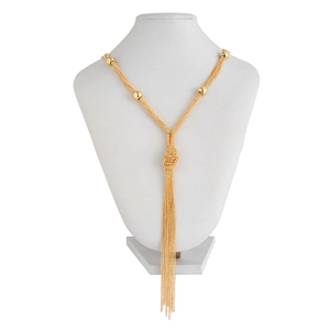 Close-up of golden multi-layer tassel necklace with CCB beads and knotted fringe detail