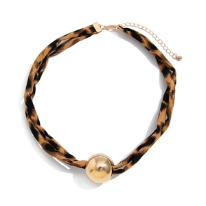 Close-up of leopard print fabric choker featuring a large polished gold ball pendant