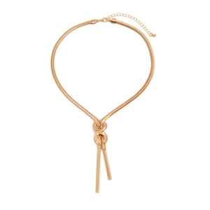 Detail of gold snake chain necklace featuring a decorative center knot and tassel design