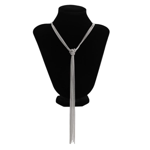 Detail view of silver multi-layer fringe necklace with intricate woven knot and tassels