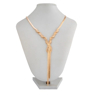 Detail showing golden flat snake chain necklace with elegant knotted tassel on white mannequin