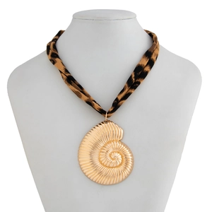 Detail of golden nautilus shell pendant with leopard print fabric cord necklace