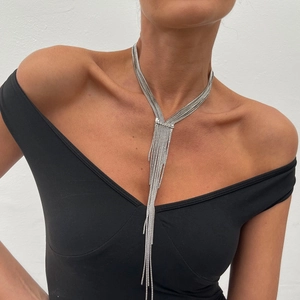 Close-up of silver minimalist multi-layer Y-shaped tassel necklace on a model