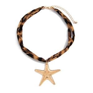 Detailed close-up of leopard print fabric necklace with sparkling gold starfish pendant