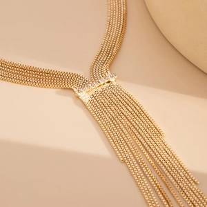 Close-up of golden multi-strand tassel necklace with sparkling rhinestone accents
