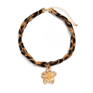 Detailed view of leopard print choker with a 3D gold metal flower pendant and lobster clasp