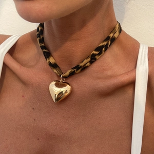 Leopard print fabric choker necklace with a polished gold metallic puffed heart pendant