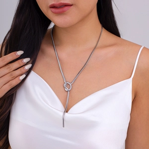 Detail of silver Y-shaped snake bone necklace showing the elegant knot and long tassel