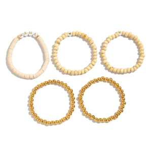 Detail of 5-piece Bohemian stackable bracelet set with MAMA letter beads and wooden pearls