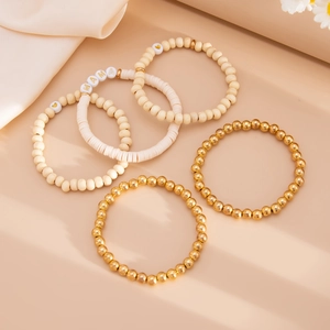 Detail of bohemian five-piece bracelet set featuring MAMA beads and clay disks