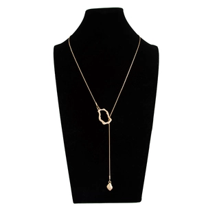Close-up of gold lariat necklace with irregular geometric loop and teardrop pendant on bust