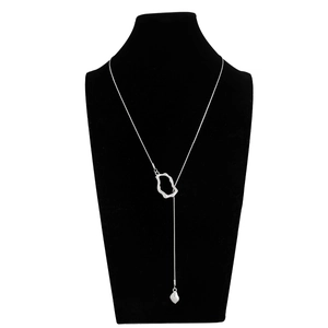 Macro detail of silver Y-shaped long necklace with irregular fluid geometric ring and droplet