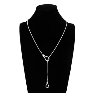 Detailed view of silver snake chain with minimalist irregular hollow pendant on black bust