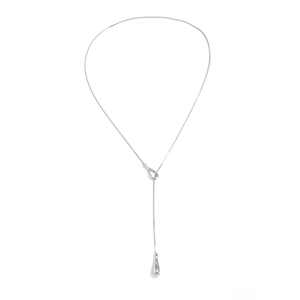 Macro detail of silver snake chain with polished teardrop pendant for women
