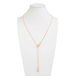 Detail of a golden Y-shaped lariat necklace featuring a smooth water drop pendant