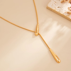 Adjustable gold snake chain necklace with smooth teardrop pendants and Y-shape design
