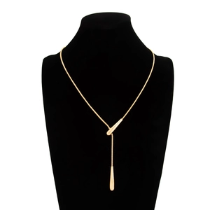 Detail of gold snake chain necklace featuring elegant double teardrop metal pendants