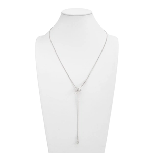 Detail of silver snake chain necklace featuring a streamlined knot and bead drop pendant