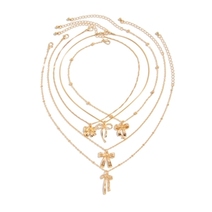 Ensemble de 5 colliers dorés avec pendentifs nœuds papillon et chaînes à étages