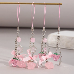 Pink strawberry pendant phone charm with sweet ribbon bow and metallic star accents