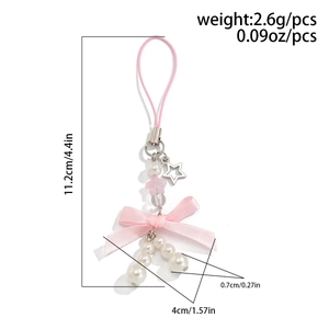 Detail of pink bow phone charm with star pendant and white pearls on white background