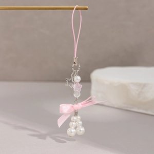 Pink bow and pearl charm with hollow star pendant on a minimalist accessory strap