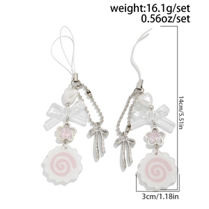 Detail of pink bow and fish cake pendant charms on silver chain with white cord
