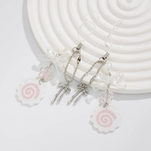 Close-up of pink spiral charms and acrylic bows on a two-piece alloy butterfly keychain