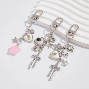 Detailed view of silver metal keychain set featuring cat heart charms and pink stars