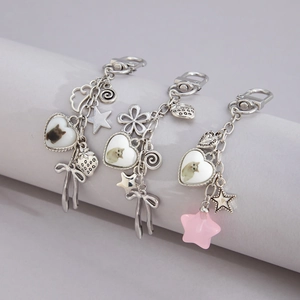 Detail of silver alloy butterfly keychains featuring acrylic heart cat pendants