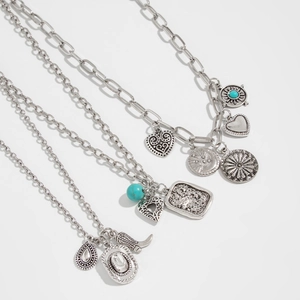 Detailed view of silver-tone Western cowboy necklaces with heart and turquoise pendants