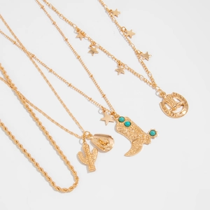 Detail of western gold necklaces with cactus, cowboy boot, and star pendants for layering