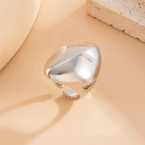 Détail d'une bague irrégulière en argent style lave liquide sur support en pierre